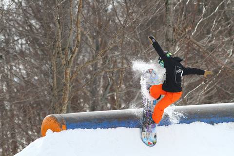 snowboarder hitting a feature in a park
