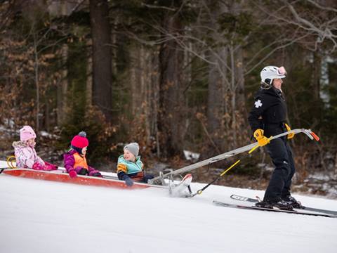 Children riding in a patrol sled