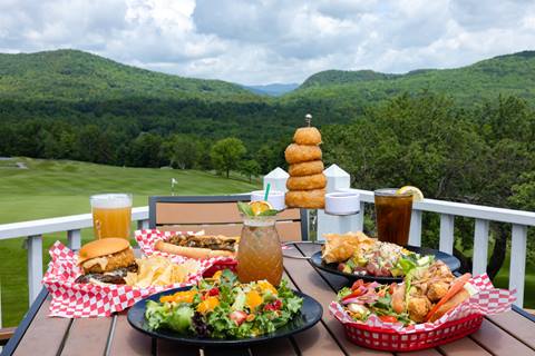 salads and sandwiches on table with golf course view