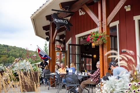 people dining on outdoor patio at rumble's
