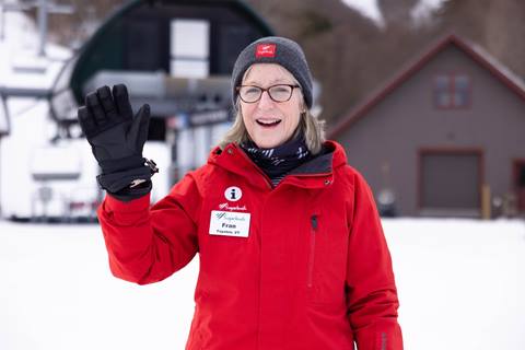 employee waving in snow