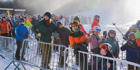 skiers waiting in lift line on sunny morning