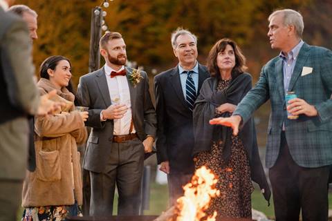 Wedding guests gather around fire pit in Lincoln Peak Courtyard