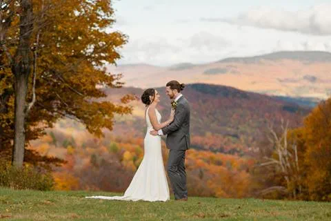 Bride and Groom in front of fall foliage mountain view